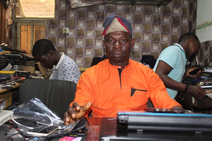 Mr Dada Adeyinka sits in his Computer Village office. Ikeja Record