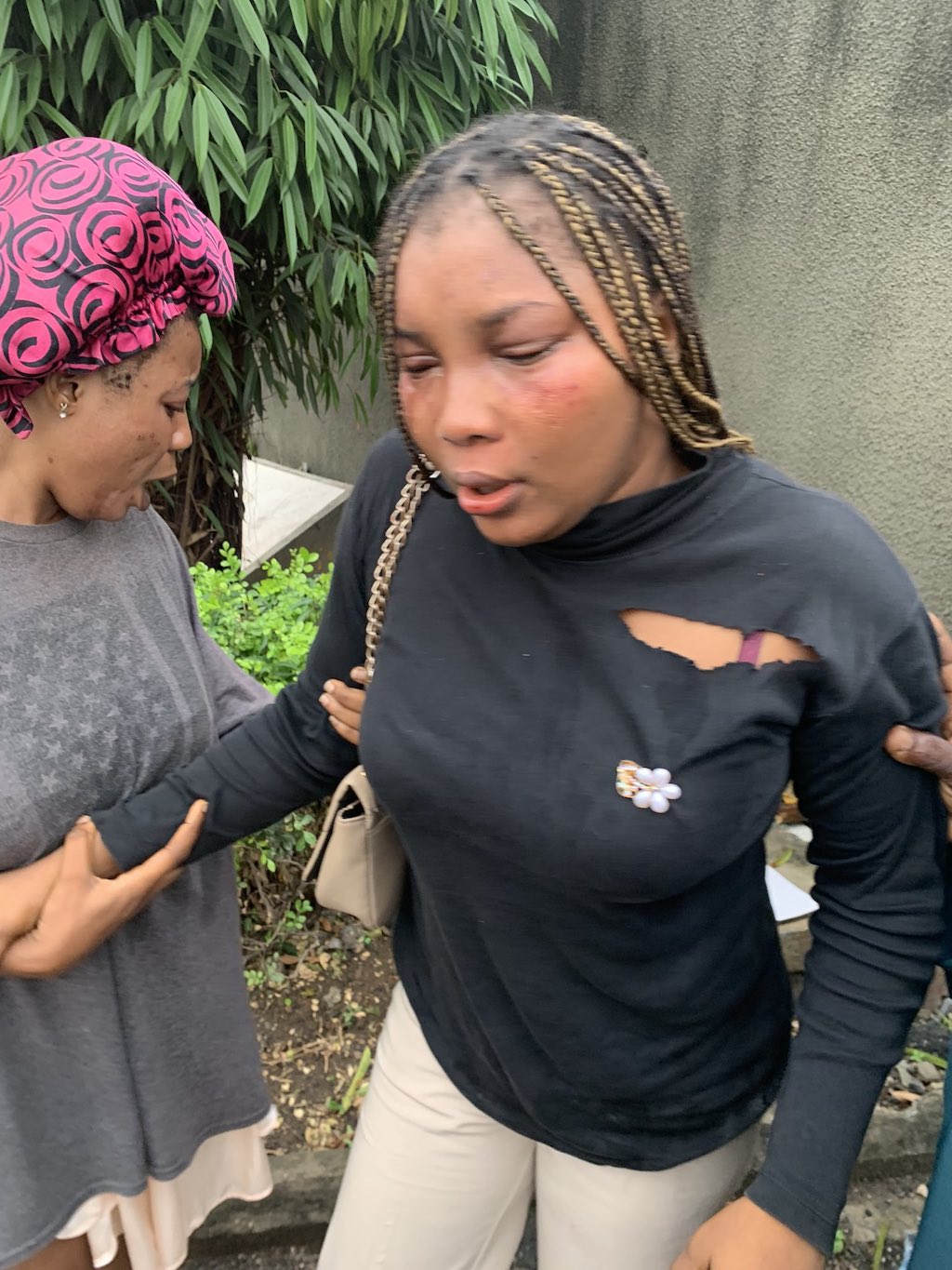 Bukola Afolarin (right) is pictured in pain.