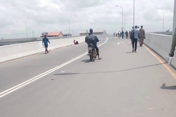 An okada rider on the overpass at the Ikeja section of the red line rail project. Credit: The Whistler