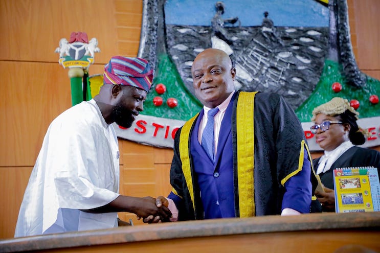 The lawmaker representing Amuwo-Odofin 2, David Doherty receives a handshake from Speaker of the Lagos State House of Assembly, Mudashiru Obasa. Credit: David Doherty / Facebook