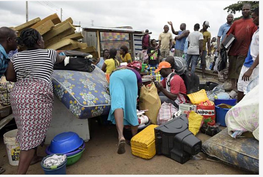 A family gathers their valuables evacuated from the homes demolished.